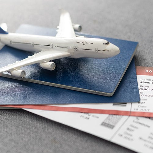 Toy airplane on travel documents