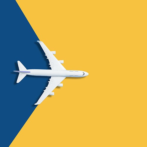 Toy airplane on blue and yellow background